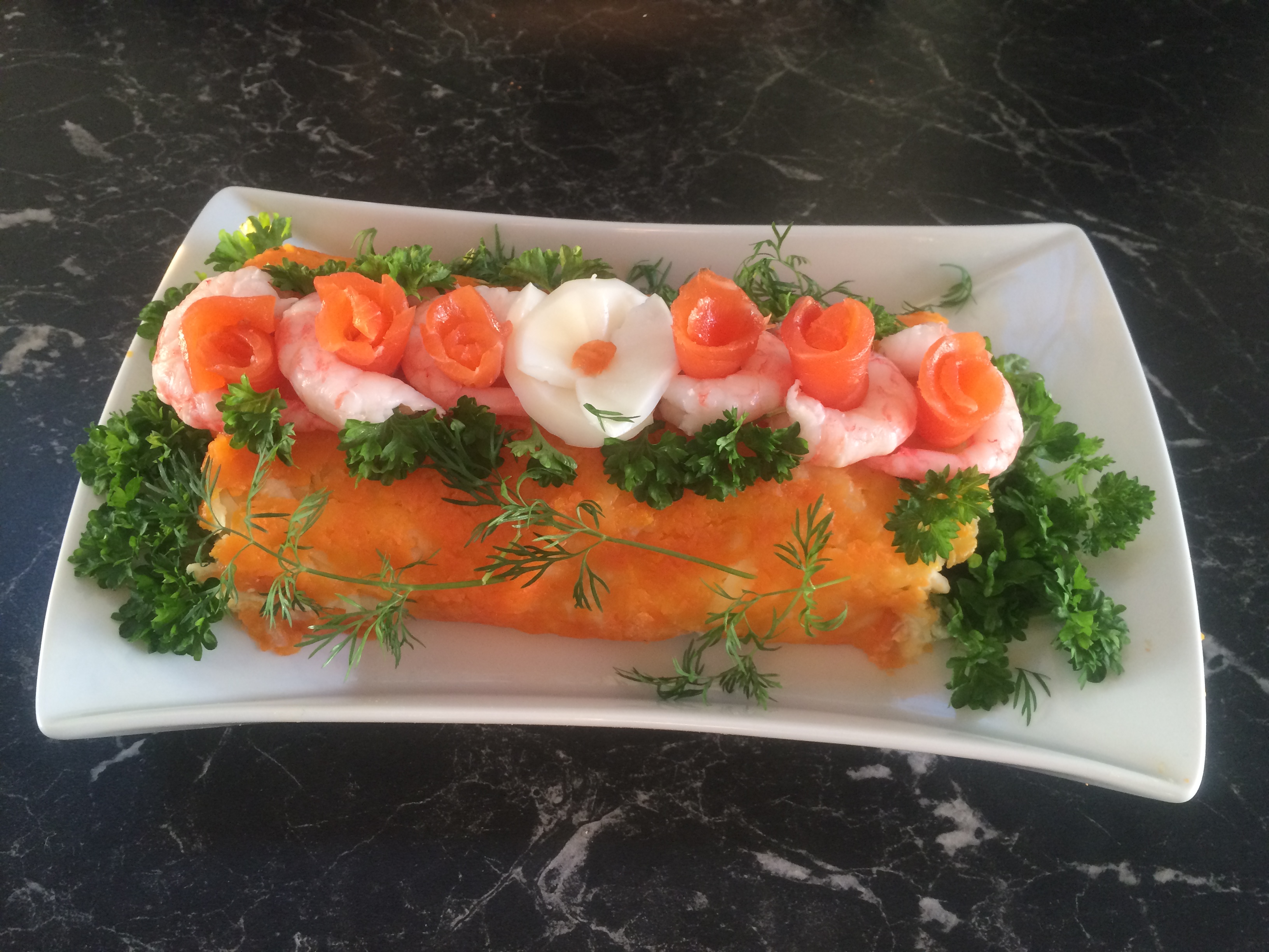  Kongens rull (Царский салат) , inneholder reker og røkt laks og er meget dekorativ. Den gjør seg godt på et pent dekket brunsjbord eller på et koldtbord