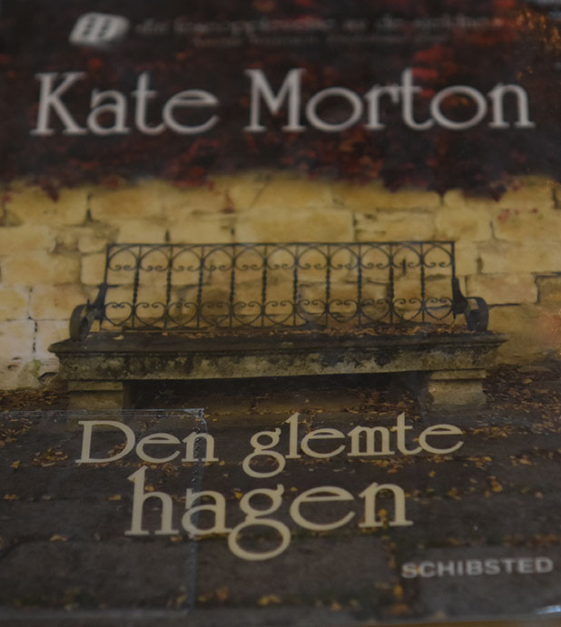 Nå har jeg endelig lest «Den glemte hagen» av Kate Morton, som er utgitt på Schisted forlag i 2011. Boka har nesten 600, men det gikk i en fei. Det må jo bety at boka er både velskrevet, lett lest og fengende. Boka begynner i London, 1913. Ei navnløs lita jente, som benevnes den lille piken, sitter gjemt (på en båt) og venter på noen, som mest sannsynlig ikke kommer. «Det var mørkt der hun satt sammenkrøpet, men den lille piken gjorde som hun var blitt bedt om. Damen hadde sagt hun skulle vente. Det var ikke trygt endå, og de måtte være stille som mus. Det var enn lek, akkurat som gjemsel. … Hun skulle ikke fortelle noe hva hun het. Det var en lek de lekte, hun og damen». Vi følger den Lille piken til Australia, hvor hun blir funnet på kaia, sittende på kofferten sin. Hvem er hun? Det er et mysterium.