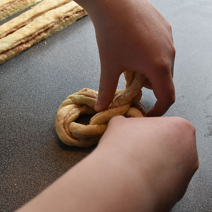 Fies Kanelsnurrer Ingredienser: 1 pk Gjær 5 dl Melk 1 Egg 1 kg Hvetemel 150 g Sukker 2 ts Kardemomme 1 ts Salt 150 g Smør (romtemperert) Fyll og pynt: 100 g Smør Sukker og kanel Egg til pensling Perlesukker