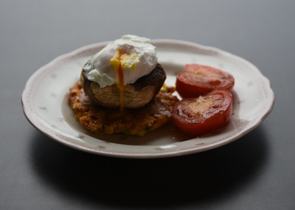 Frokoststabel med mais, sopp og egg Ingredienser: 4 Sjampinjonger (store) 4 Tomater (store, modne) Olivenolje 150 g Maiskorn 200 g Ost (hvit, revet) 2 Vårløk (hakket) 1 cm Ingefær 2 ts Gurkemeie ½ ts Spiskummen 2 ss Dill (fersk, hakket) 2 ss Persille (fersk, hakket) 2 ss Hvetemel 1 ts Salt Salt, pepper 6 Egg 2 ts Eddik