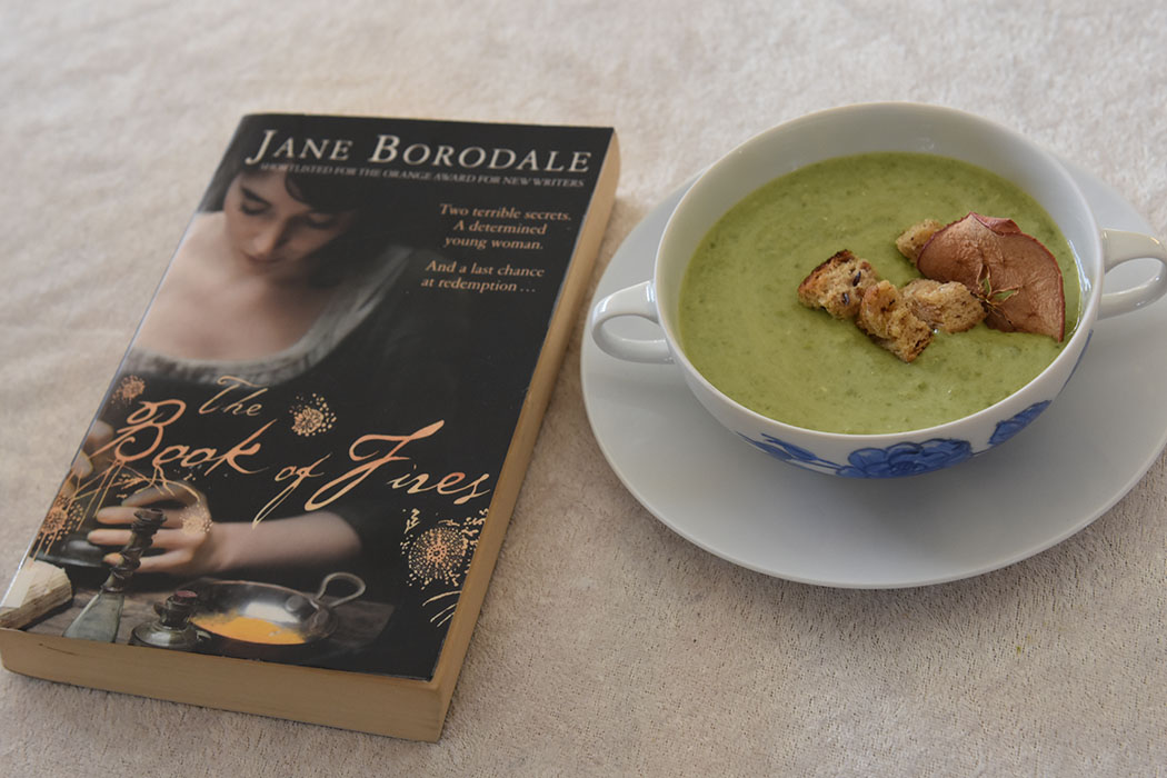 Borodale, Jane (2009) «The book of fire», Harper Press OG Grønn ertesuppe Ingredienser: 2 ts Olje (raps) 1 Løk (hakket) 2 fedd Hvitløk 600 g Erter (grønne, frosne) 7 ½ dl Vann 2 terninger Grønnsaksbuljong 2 dl crème fraiche Salt og pepper Tilbehør og garnityr: 2 ss Smør 2 skiver Brød 4 Egg (nesten hardkokte) Erter