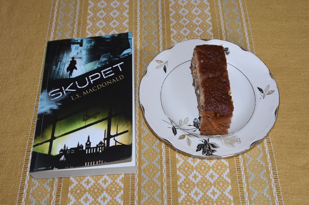 LS Macdonald (2021) «Skupet», Macademics Forlag OG KRISTINS BANANBRØD Ingredienser: 2 ½ dl Hvetemel 2 ts Bakepulver 1 ts Vaniljesukker 1 ts Kardemomme (valgfritt) 2 Egg 1 ½ dl Sukker 50 g Smør 1 dl Melk 40 g Kokesjokolade (mørk, hakket) 40 g Valnøtter 2 Bananer (godt modne, gjerne med brune flekker) Topping: 10 g Kokesjokolade (mørk, hakket) 10 g Valnøtter 1 Banan https://heidisboble.no/ @heidisboble